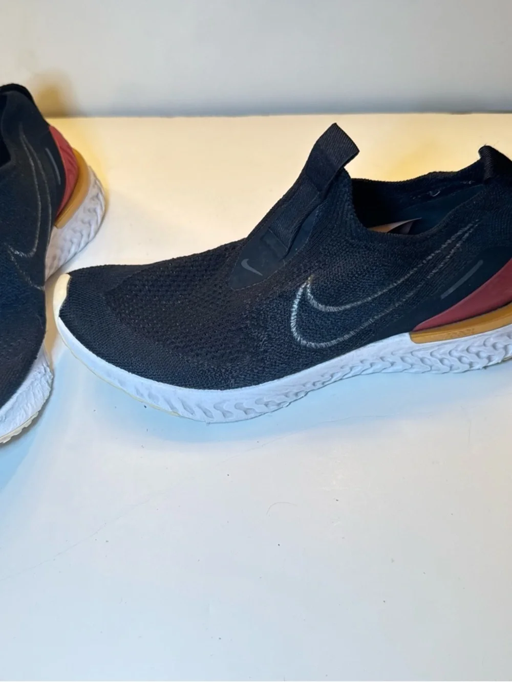 Nike Black Slip-On Athletic Shoes with Orange Heel Accent